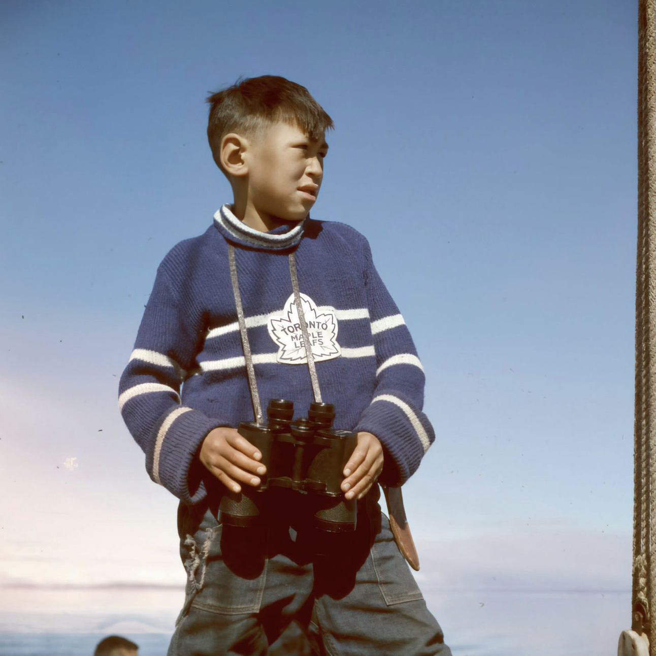 A young boy wearing a Toronto Maple Leafs sweater in Frobisher Bay, NWT(now Iqaluit, Nunavut) in 1960